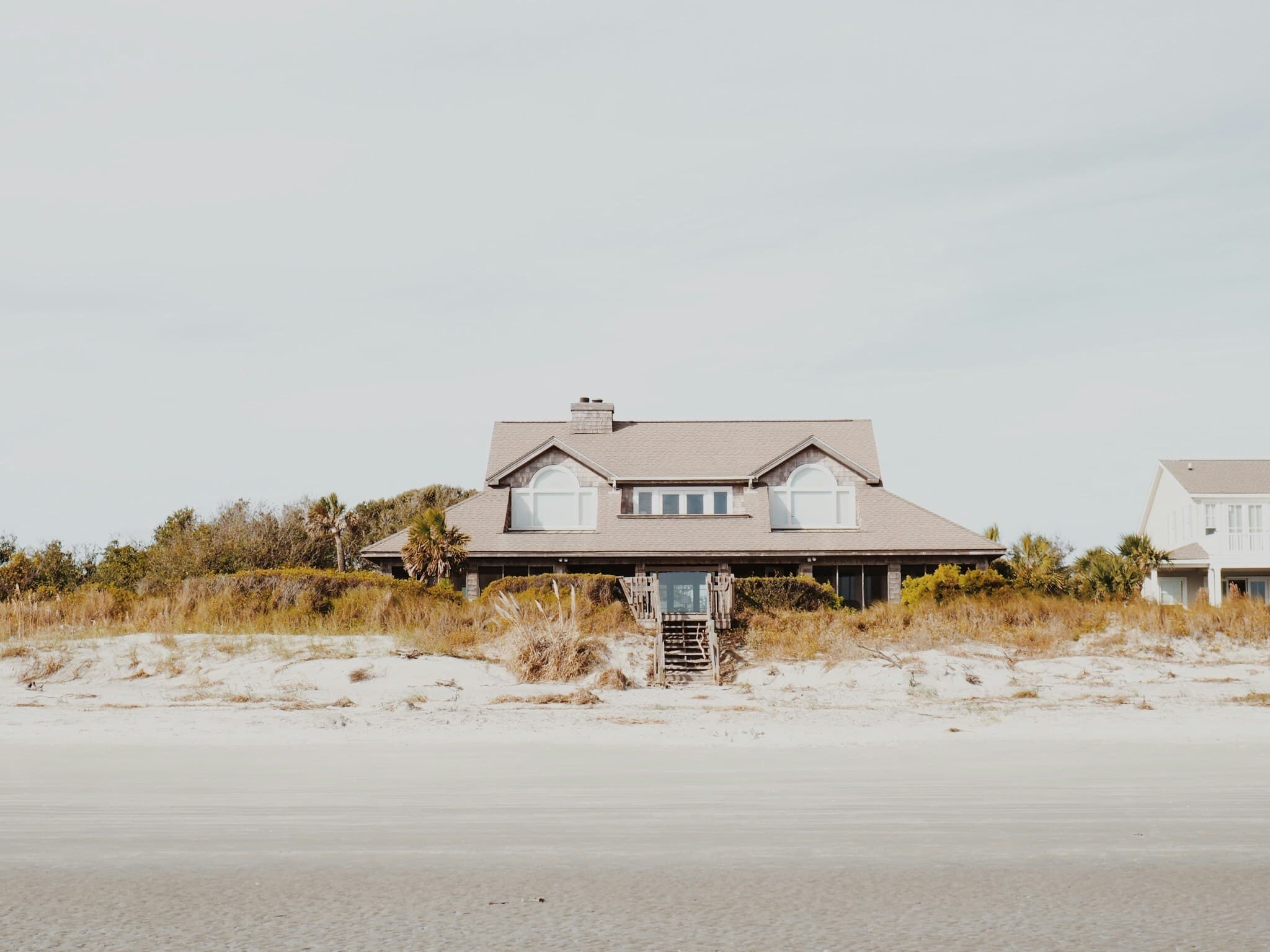 Shingled coastal home seen from the beach